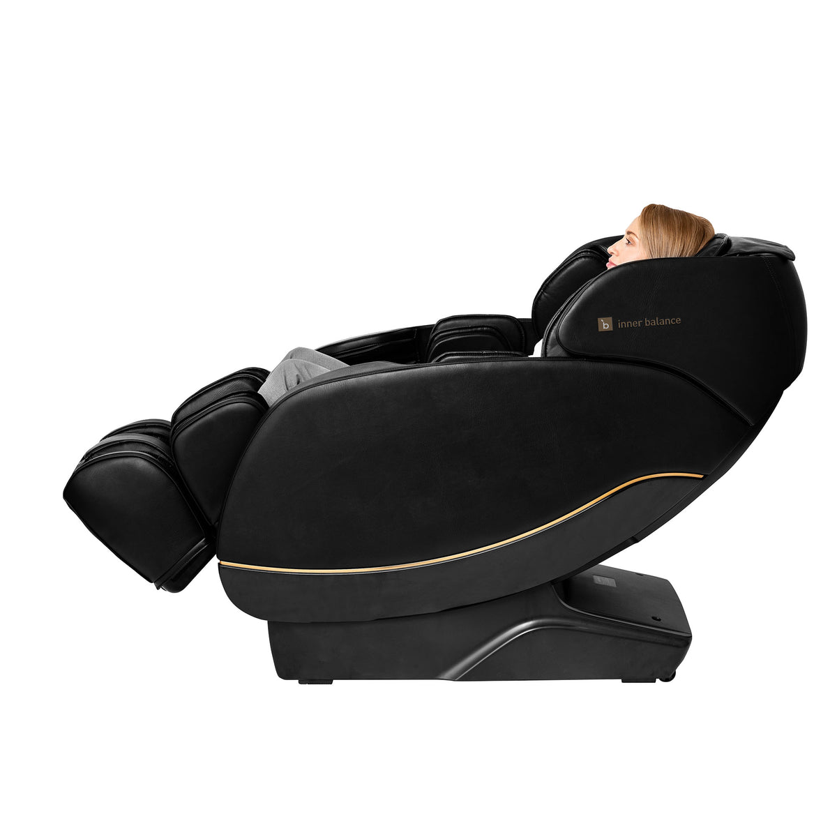 Side view of a person relaxing in a partially reclined Inner Balance Wellness Jin 2.0 Massage Chair in classic black with gold trimming