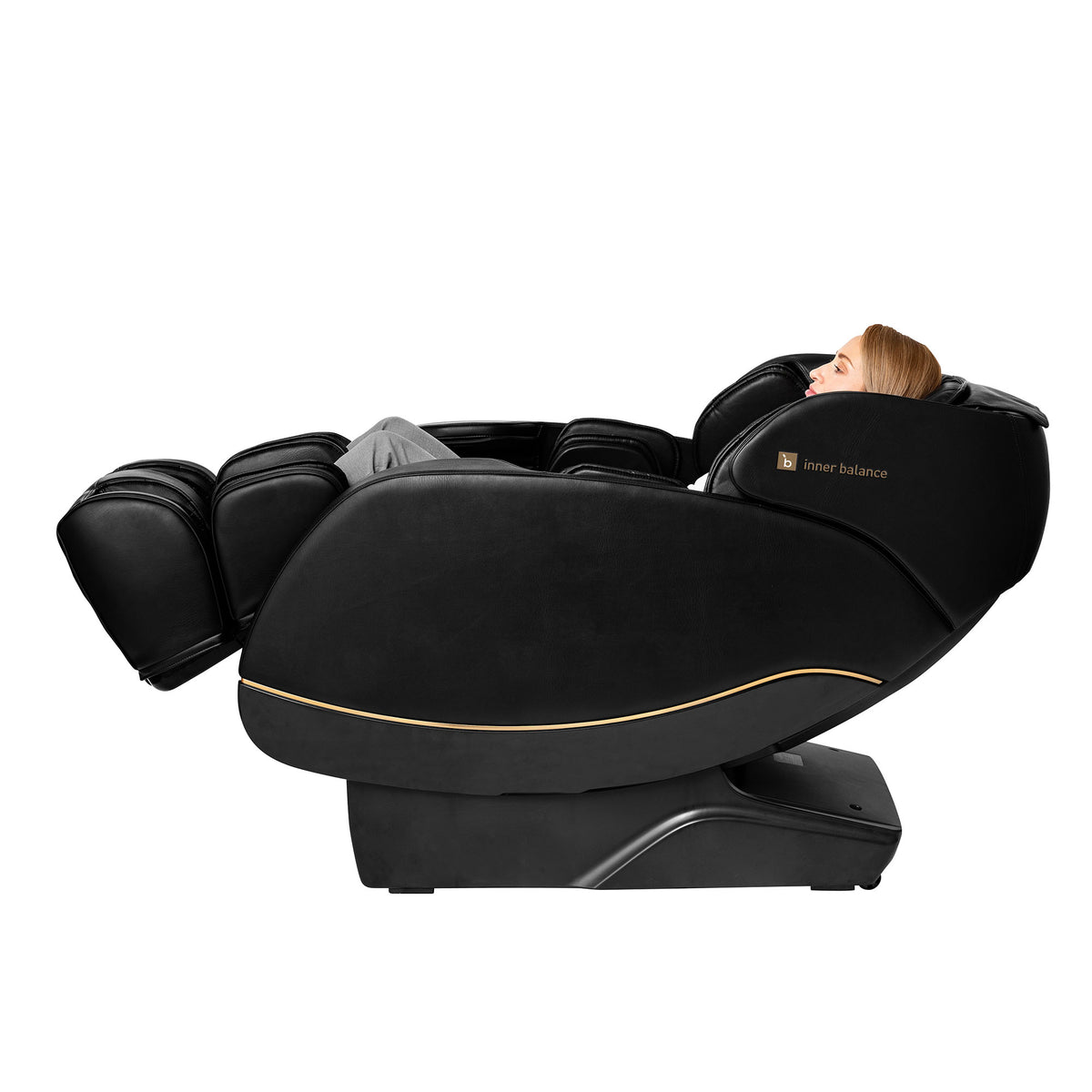 Side view of a person relaxing in a fully reclined Inner Balance Wellness Jin 2.0 Massage Chair in classic black with gold trimming