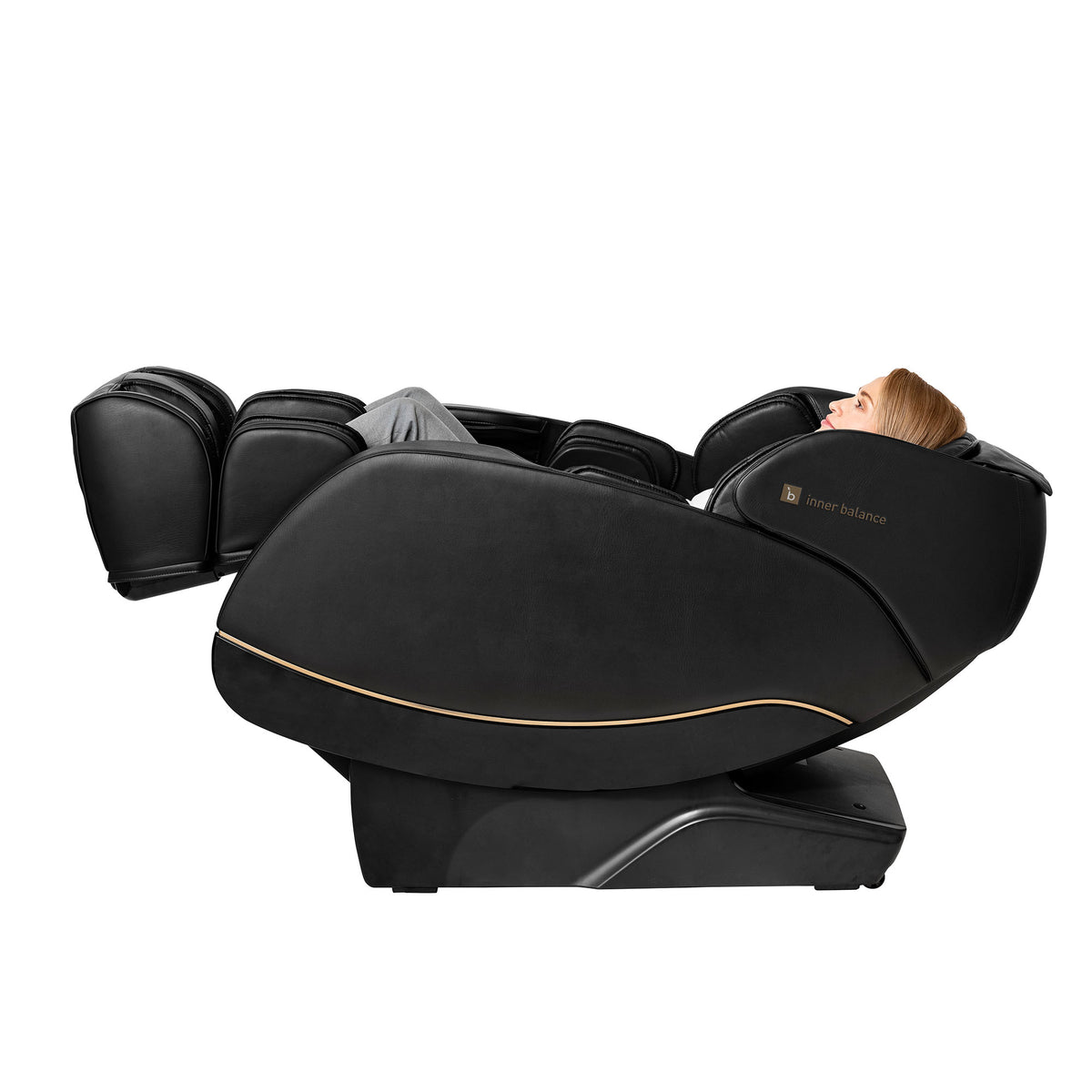 Side view of a person relaxing in a fully zero-gravity reclined Inner Balance Wellness Jin 2.0 Massage Chair in classic black with gold trimming