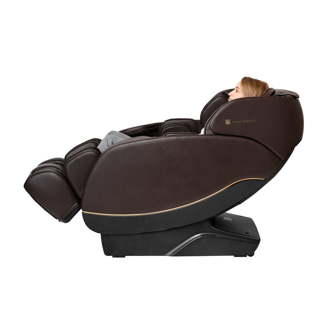 Side-view of a woman enjoying a partially reclined Inner Balance Wellness Jin 2.0 Massage Chair in brown leather with detailed stitching